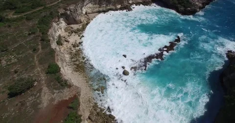 4K HIGH ANGLE FLY BY OF MASSIVE WAVES HITTING ROCK CLIFFS AND BEACH Stock Footage 60001097