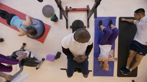 4K High angle view of diverse group working out with different exercises in gym Stock Footage 75887464