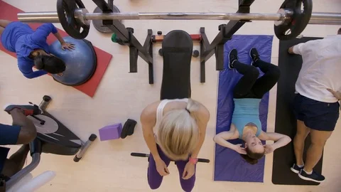 4K High angle view of diverse group working out with different exercises in gym Stock Footage 75887687