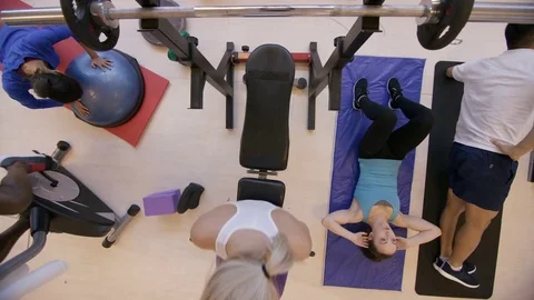 4K High angle view of diverse group working out with different exercises in gym Stock Footage 75888725