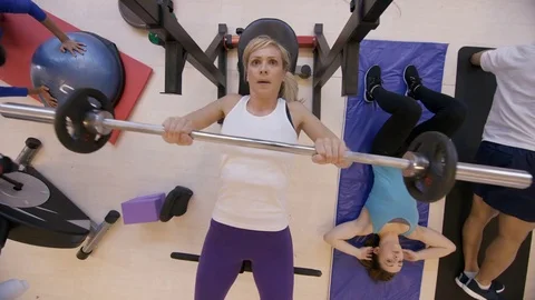 4K High angle view of diverse group working out with different exercises in gym Stock Footage 75889541