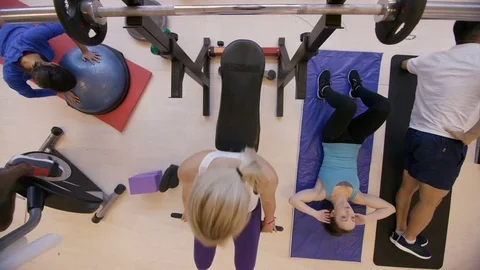 4K High angle view of diverse group working out with different exercises in gym Stock Footage 75889832