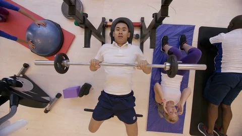 4K High angle view of diverse group working out with different exercises in gym Stock Footage 75897802