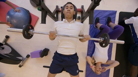 4K High angle view of diverse group working out with different exercises in gym Stock Footage 75899245