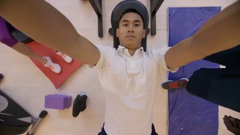 4K High angle view of man lifting weights with personal trainer in the gym Stock Footage 75884218