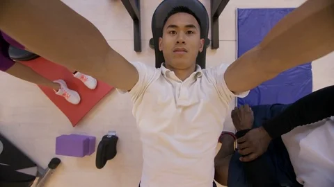 4K High angle view of man lifting weights with personal trainer in the gym Stock Footage 75884701