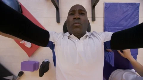 4K High angle view of man lifting weights with personal trainer in the gym Stock Footage 75885472