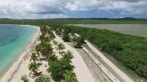 4K High Up Down the Beach with Bay Stock Footage 63473029