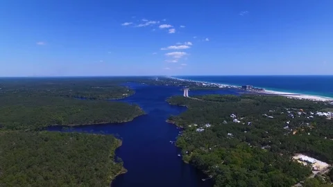 4K High Drone Backing Up Over River With Ocean in Background Stock Footage 109356613