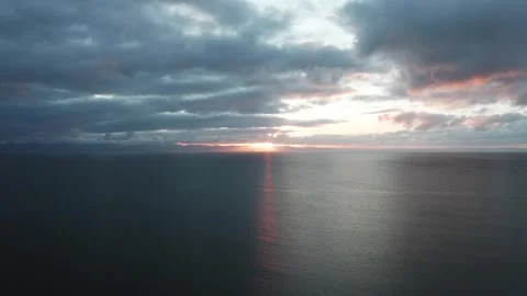 4K high drone shot over the sea off the Welsh coast during sunrise 库存影片 296803829