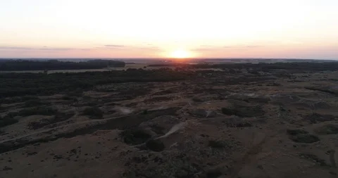 4K High Sunset on Horizon from Drone Over Sand Dunes and Forest Vídeo Stock 93238997