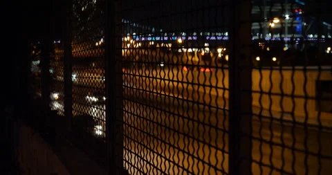 4K HIGHWAY SHOT THROUGH WIRE FENCE AND CARS PASSING Stock Footage 131280837