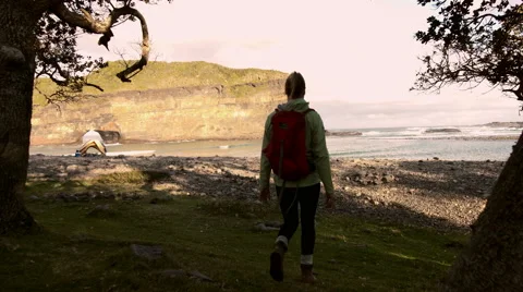 4k Hiker walking towards yellow tent at coastal camp. Sports recreation Stock Footage