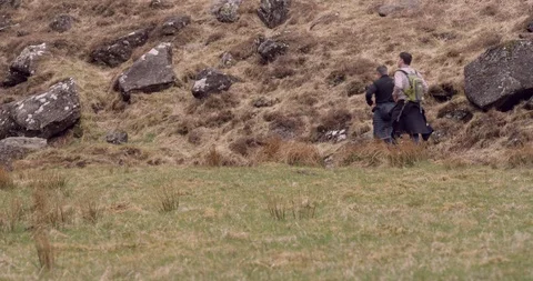 4K Hikers in the Scottish Glen Coe Mountain Highlands. Trekkers Backpacking. Stock Footage 93038982