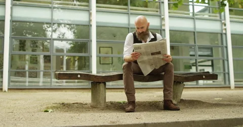 4k, Hipster businessman reading a newspaper while on a lunch break Stock Footage