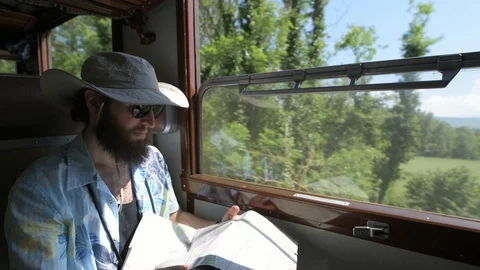 4K hipster checking map travelling on vintage train Stock Footage 90813476