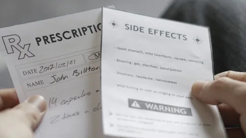 4K Holding a Medical Prescription With Side Effects Warning Stock Footage 73386437