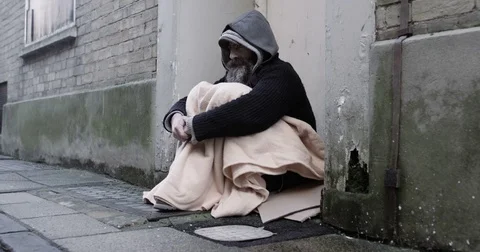 4k, Homeless man sitting on a sidewalk during winter. Slow motion. Stock Footage 72436053