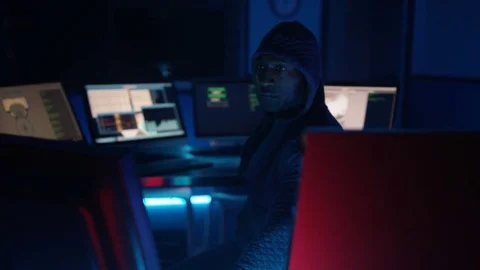 4K Hooded computer hacker trying to break a code on computer system Stock-Footage 73377640