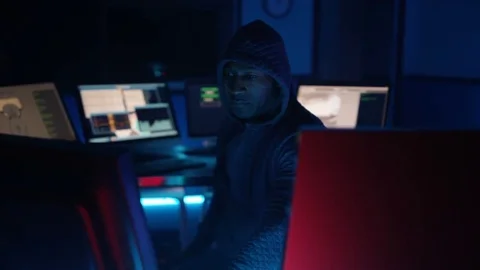 4K Hooded computer hacker trying to break a code on computer system Stock-Footage 73377776