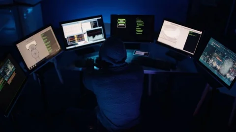4K Hooded computer hacker trying to break a code on computer system Stock-Footage 73378367