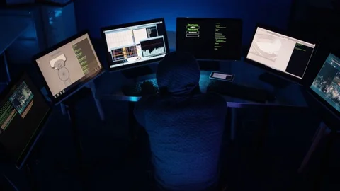 4K Hooded computer hacker trying to break a code on computer system Vidéo 73379336