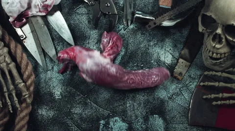 4k Horror and Bloody Composition of a Cannibal Throwing Raw Meat Stock Footage