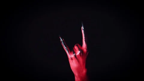 4k Horror Halloween Devil's Hand Showing Rock Stock Footage 81537824