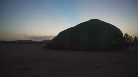 4K Hot air balloon being inflated at the crack of dawn in North Africa Stock Footage 100433732