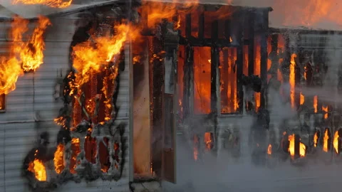 4K Hot flames rising as a small building is destroyed by a large fire. Slow Stock Footage 232337327