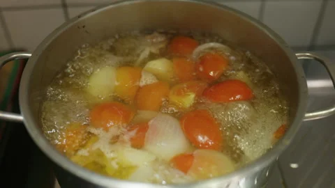 4K Hot soup boiling in a pot on home kitchen stove Stock Footage 337711040