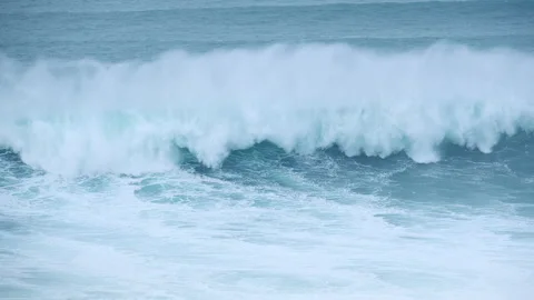 4K huge Atlantic waves with surfer and jet ski safety team at Praia do Norte Naz Stockbeeldmateriaal 329659024