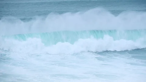 4K huge Atlantic waves with surfer and jet ski safety team at Praia do Norte Naz Stock Footage 329659981