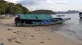 4k Human pollution trash and primitive fisherman boat at dirty beach 4k or 4k+ Resolution