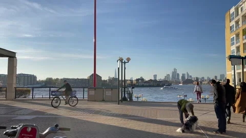 4K human traffic walking towards steps down canary wharf ferry terminal Stock Footage 221155304