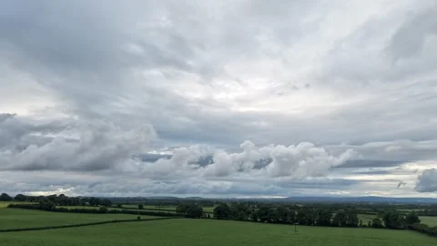 4K Hyperlapse of Dramatic Cloudy Sky Over Green Fields Video stock 337856095