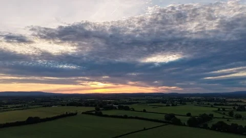 4K Hyperlapse of Dramatic Cloudy Sky Over Rural Fields at Sunset Video stock 338307213