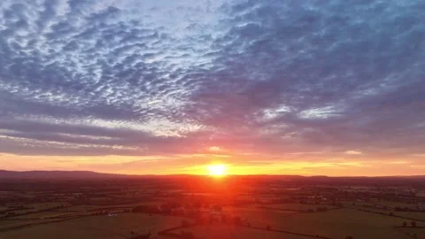 4K Hyperlapse of Sunset Over Rural Fields Beneath Dramatic Cloudy Sky Stock Footage 338307212