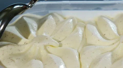 4K Ice cream scoop, scooping into a dish of softly melting vanilla ice cream Stock Footage