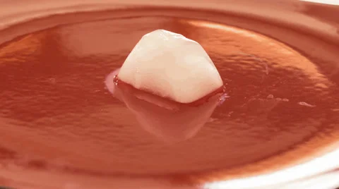 4K Ice cube timelapse melting and moving on a plate Stock Footage 40127260