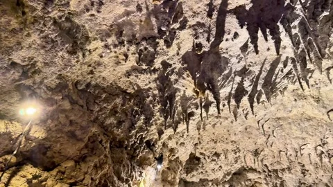4K Illuminated Limestone Cave Wall and Rock Formations Stock Footage 345373237