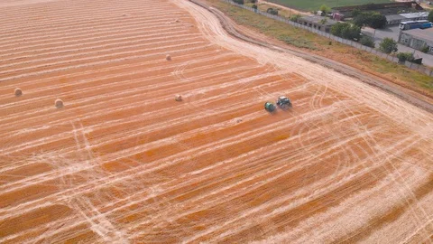 4K impressive flight over a working combine harvesting tons of ripe barley Stock Footage 126656048