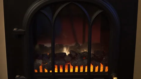 4K indoor fake fire place black flames yellow orange, typical british Stock Footage 59798326