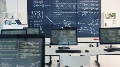 4K Interior of empty classroom with computers &amp; math formulas on blackboard Stock Footage 73190247