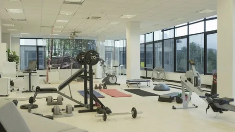 4K Interior of empty modern gym with video screen showing moving outdoor scene Stock Footage 75846465