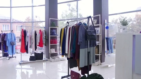 4K Interior of fashionable women's clothes store with clothes racks & mannequins Stock Footage