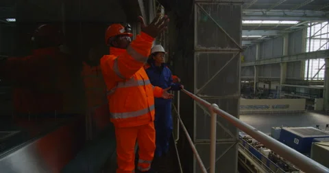 4K Interior view of huge industrial power plant & male & female engineers Stock Footage