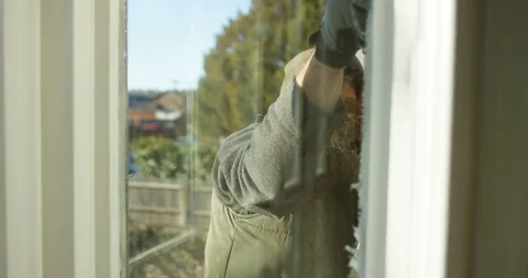 4K Interior view of man working outside, doing repairs to house window trim Stock Footage 88229792
