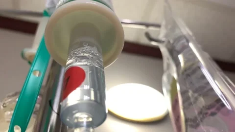 4k Intravenous drip close up in focus in hospital room tilt up view Stock Footage 135950571