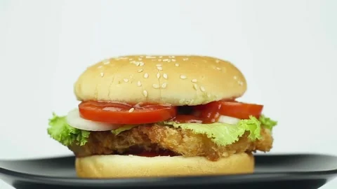 4k. Isolated hamburger rotates on white background, Juicy cooked beef burger Video stock 336578696